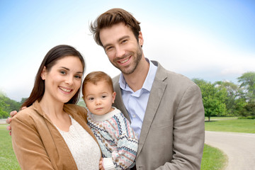 Portrait of happy family standing in park