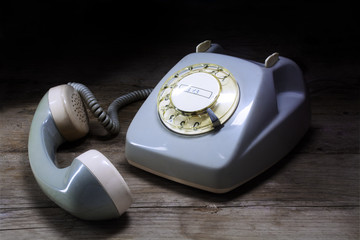 retro rotary telephone with rotary dial and removed receiver on