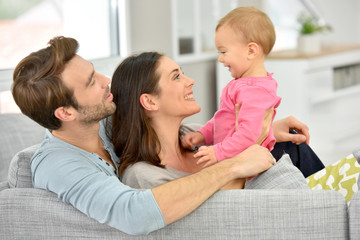 Couple with baby girl enjoying family time at home