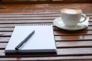 Coffee of cup and empty notepad