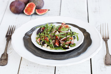 Salad with figs ,prosciutto , arugula and Parmesan cheese seasoned with balsamic sauce..selective focus