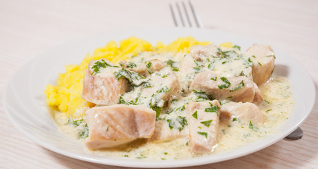 chicken breast in a creamy sauce with mashed potatoes