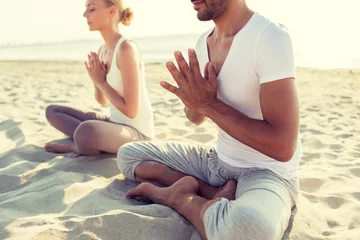 Foto op Canvas close up of couple making yoga exercises outdoors © Syda Productions