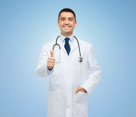 smiling doctor in white coat showing thumbs up