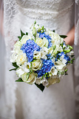 Beautiful wedding a bouquet in hands of the bride