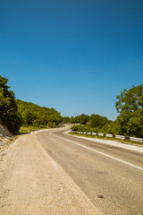 Fototapeta na wymiar Curved asphalt road in mountains 