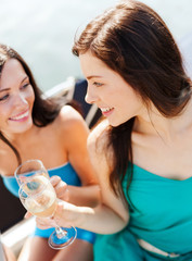 girls with champagne glasses on boat