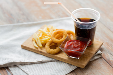 close up of fast food snacks and drink on table