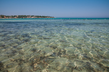 Beach in the clear sea of Sicily with a pedalo for fun people
