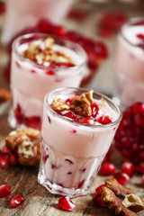 Homemade garnet yogurt with walnuts and pomegranate seeds, selec