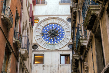 Antique clock on the wall. Venice is one of the world's most popular tourist destinations with 21 million visitors per annum