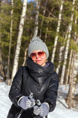 Happy young woman skiing in the winter forest