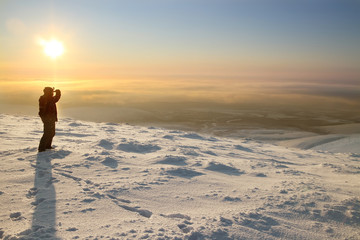 Skier on the mountain. Looking into the distance. Evening