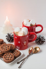 Christmas style. Coffee in red mugs with cookies and marshmallow. Winter time.