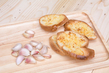 crispy garlic bread in wood tray