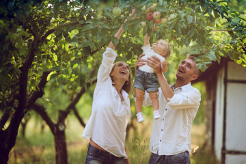 Families with a child in the summer garden