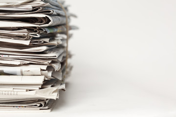 A stack of newspapers. Focus on near edge of stack.