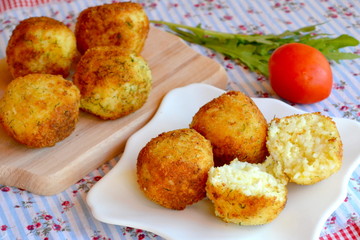 Italian appetizer arancini, rice balls cooked in deep fat