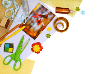 Arrangement of scrapbooking or card making tools and materials, with copy space. Pure white background, soft shadows.
Note: I own the copyright for the fall leaves photograph pictured in this image.