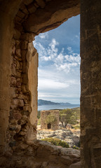 View of derelict building and coast near Galeria in Corsica