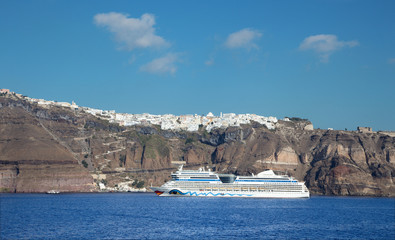 Santorini - cliffs of calera with the cruise and Fira town in the background.