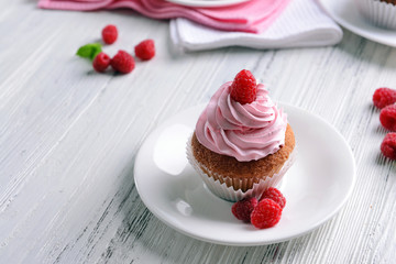 Delicious cupcake with berries on table close up