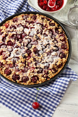 Tasty homemade pie with cherries on table close up