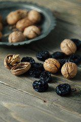 walnuts and dried plums on wooden table