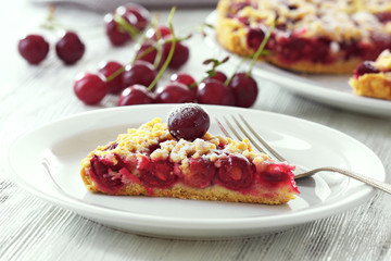 Tasty homemade pie with cherries on table close up