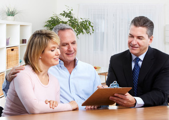 Senior couple with real estate agent.