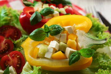 Fresh green salad in pepper on table close up