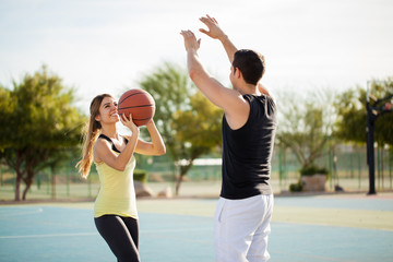 Pretty couple shooting some hoops