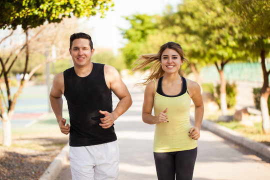 Cute Hispanic couple jogging together