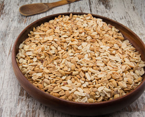 Peanuts. Close up of fried, peeled and salted peanuts in a wooden plate