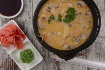 Tom Yum Goong spicy soup traditional food cuisine in Thailand on wooden background