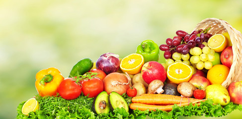 Fruits and vegetables over green background.