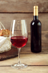 Still life of wine and bread on light background