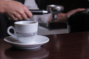 Close up of waitress  hands preparing espresso coffee. Service and restaurant concept