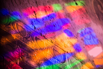 Reflections of a colored staines glass window in a church