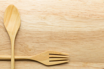 Wooden spoon and fork on wood background