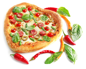 Tasty heart shaped pizza decorated with hot peppers and basil isolated on white background