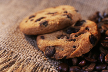 Close up view on cookies with chocolate crumbs and roasted coffee on Hessian