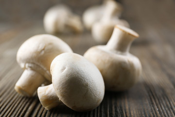 Champignon mushrooms on grey wooden background