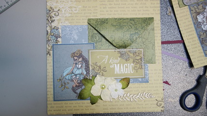the process of handmade creating of the album from special scrapbooking paper, paper flowers and other decorative elements