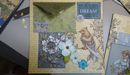 the process of handmade creating of the album from special scrapbooking paper, paper flowers and other decorative elements