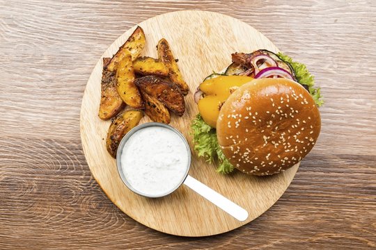 Fresh hamburger on wooden table. Stock image macro.