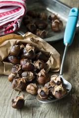 Freshly roasted sweet chestnuts in a paper bag
