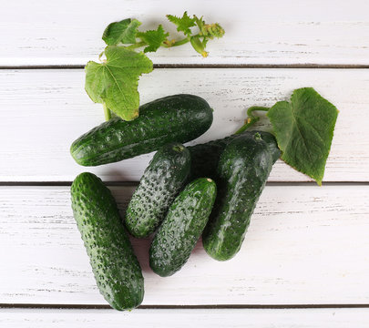 Cucumbers on light wooden background