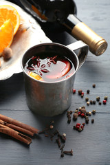 Beautiful composition of traditional mulled wine on decorated grey wooden background, close up