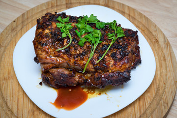 Homemade baked meat with parsley on a wooden board